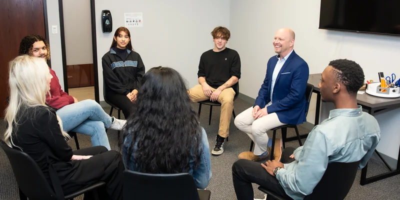 Small group seated in a circle for discussion.