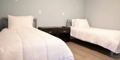 Bedroom with two twin beds and a shared nightstand.