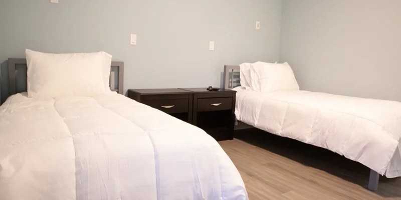 Bedroom with two twin beds and a shared nightstand.
