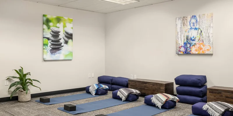 Yoga room with mats and cushions.
