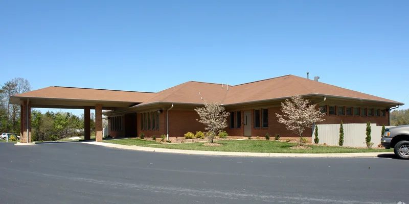 Facility building with entrance and accessible parking.
