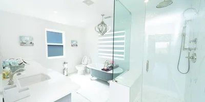 Modern white bathroom with glass shower and soaking tub