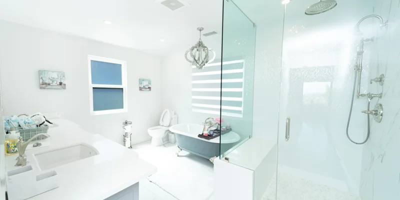 Modern white bathroom with glass shower and soaking tub