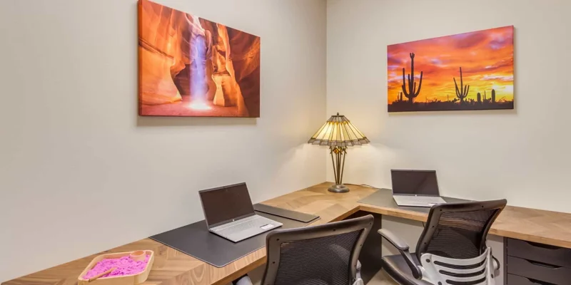 Office space with seating and a l-shaped desk.