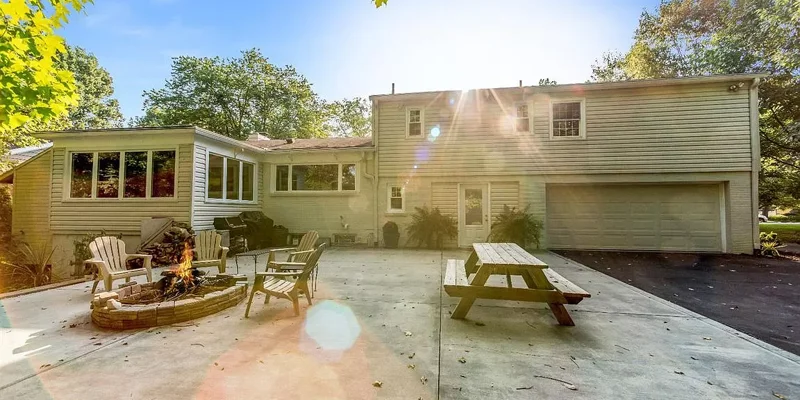 Outdoor backyard wth seating and fire-pit.