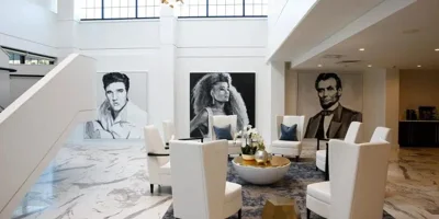 Grand lobby with high ceilings and celebrity portraits.