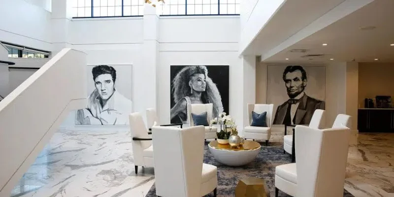 Grand lobby with high ceilings and celebrity portraits.