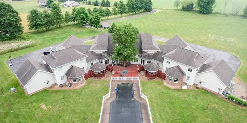 Aerial view of the facility's backyard with a closed-off pool area.
