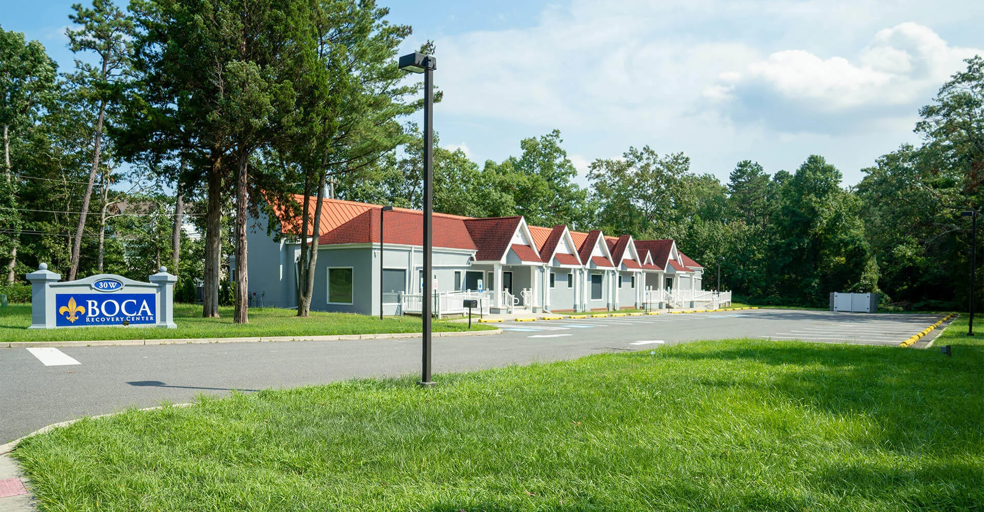 Facility exterior with buildings, parking and signage.