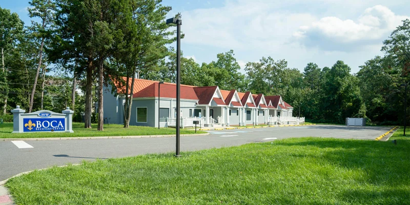 Facility exterior with buildings, parking and signage.