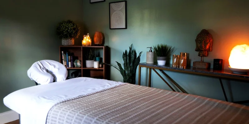 Massage room with a table, candles and decor,