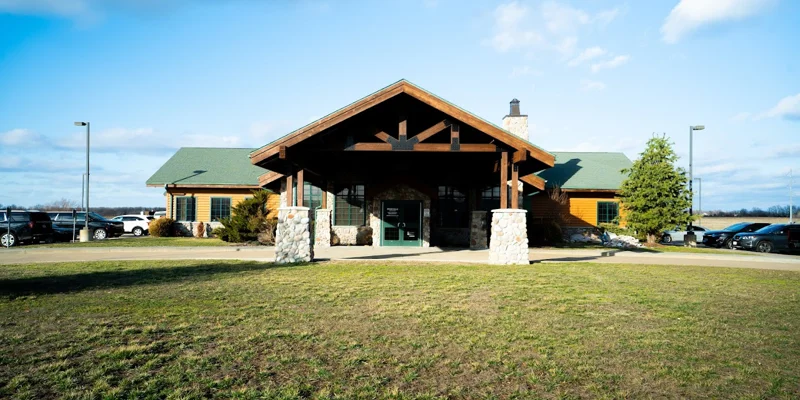 Rehab facility with a rustic lodge-style exterior and stone pillars.
