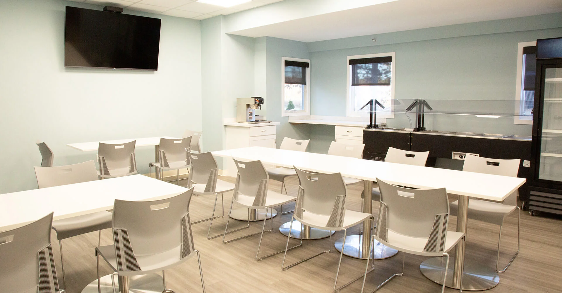 Dining area with seating, a TV, and a buffet station.
