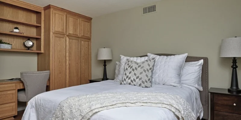Private bedroom with bed and side-tables.