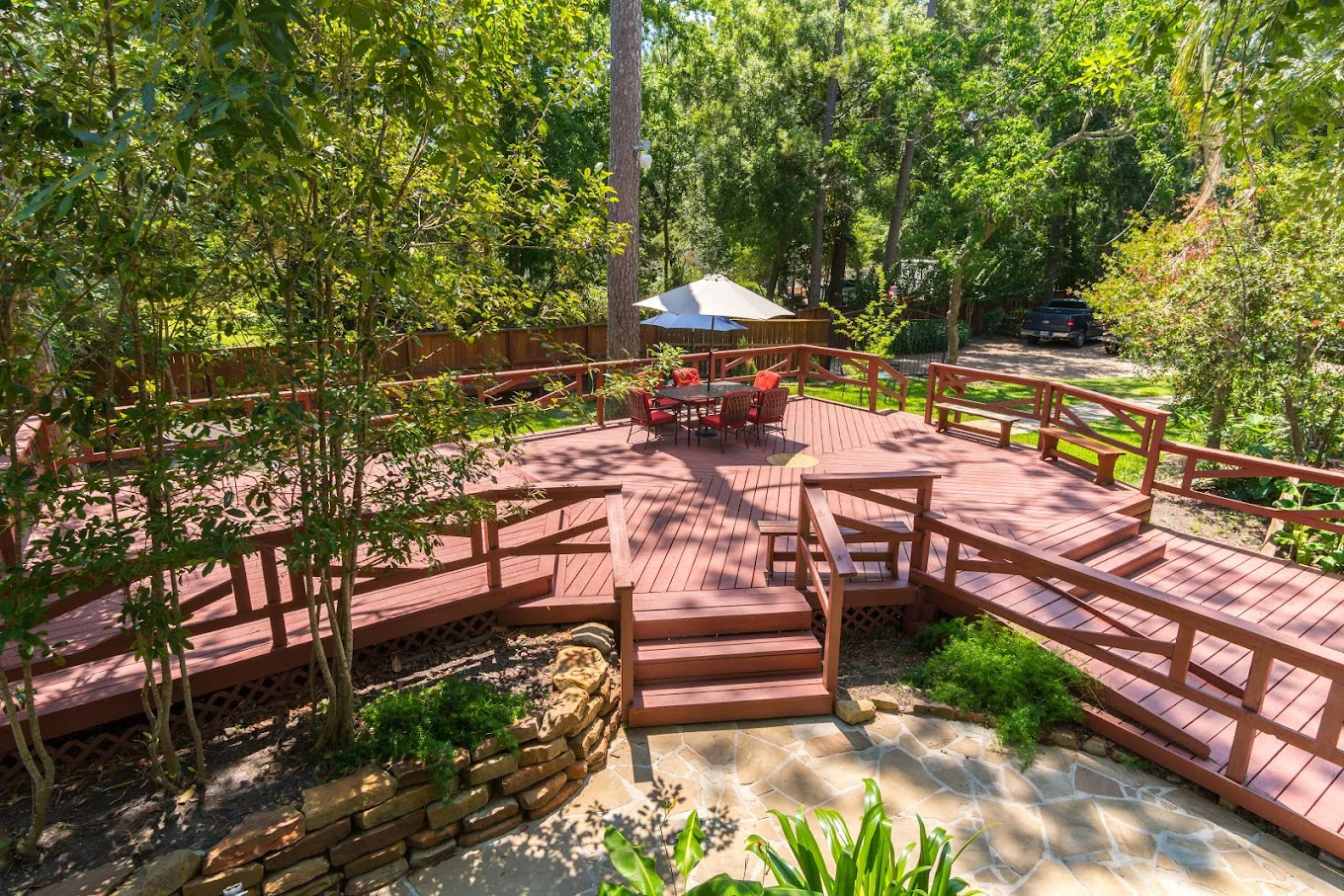 Deck with seating area under shading.