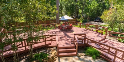 Deck with seating area under shading.