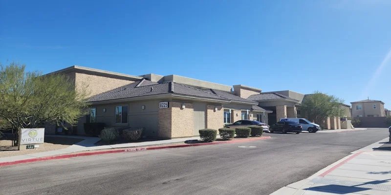 Facility exterior with entrance and accesible parking before the entrance.