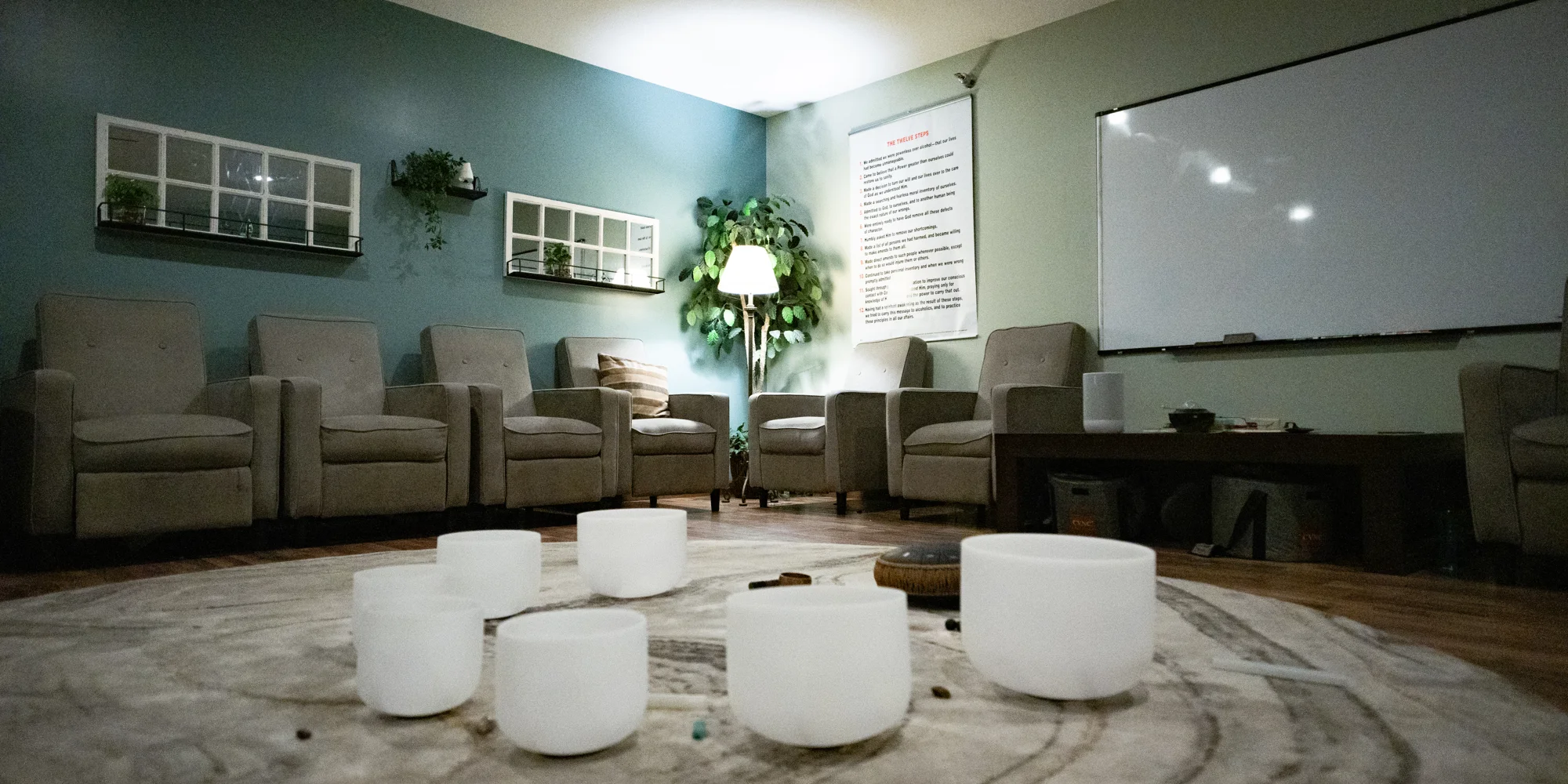 Group therapy circle with cushioned chairs and whiteboard