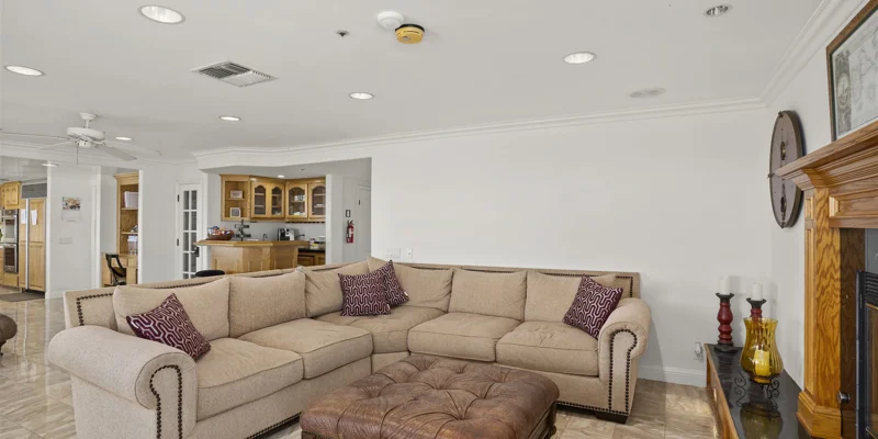 Open living space with a large sectional sofa and wooden fireplace.