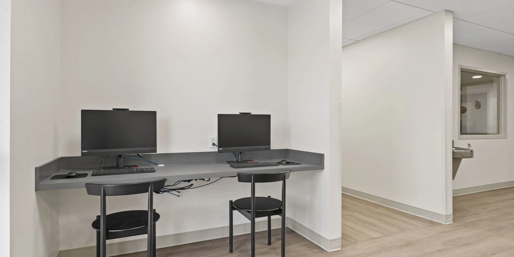 A small workstation with two computers for residents.