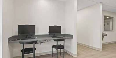 A small workstation with two computers for residents.