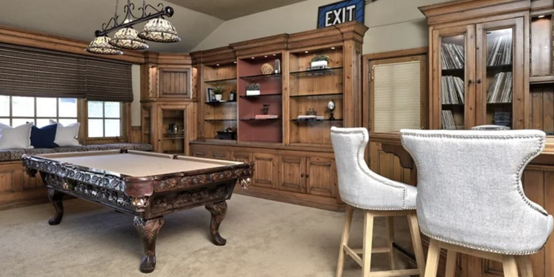 Common room with a pool table and plush seating.