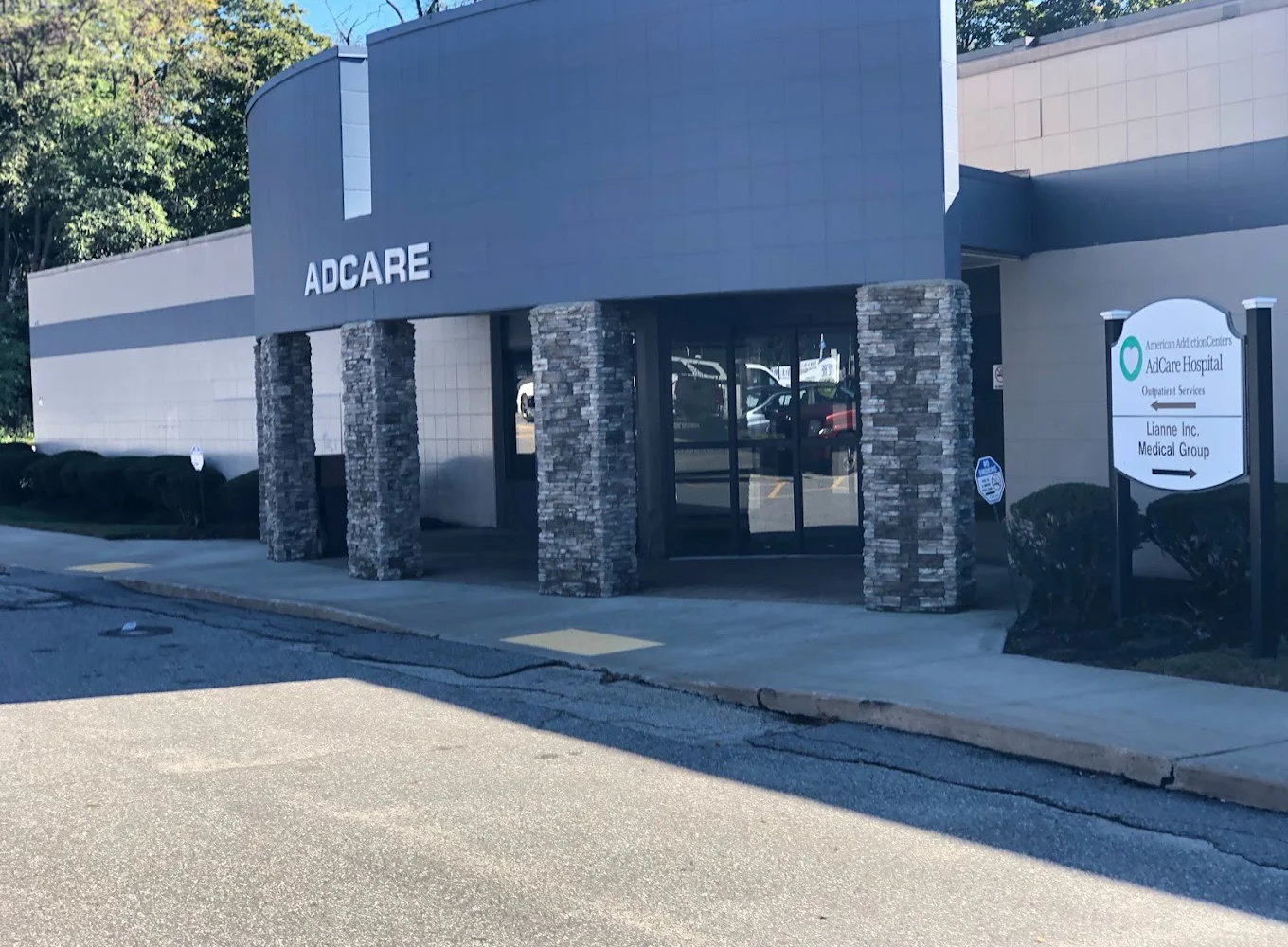 uilding exterior with AdCare sign and large windows.