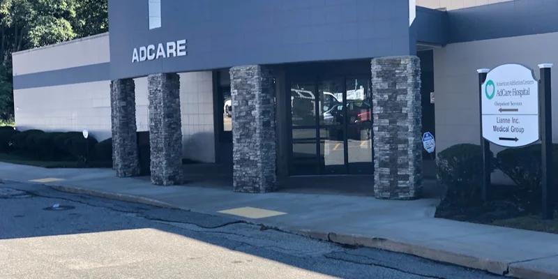 uilding exterior with AdCare sign and large windows.
