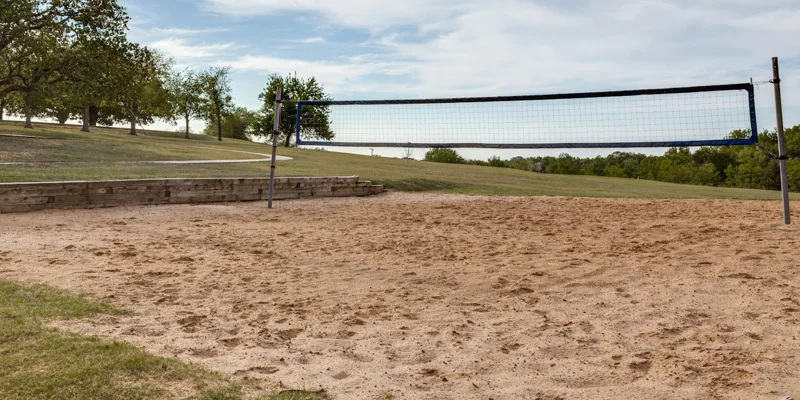 Outdoor sand volleyball court with a scenic landscape view