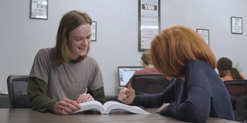 Two people studying together at a table.