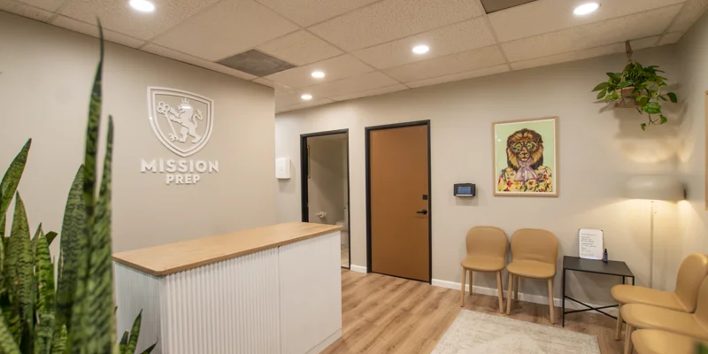 Reception area with a wooden desk and "Mission Prep" logo on the wal