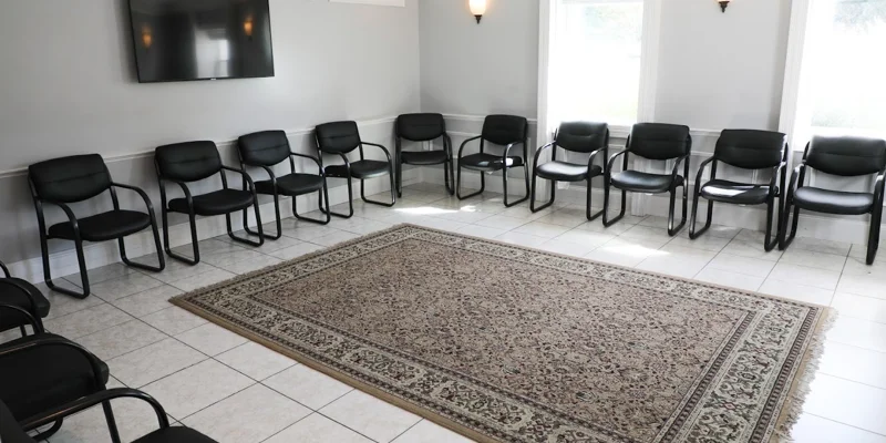 Group therapy room with chairs along the wall.
