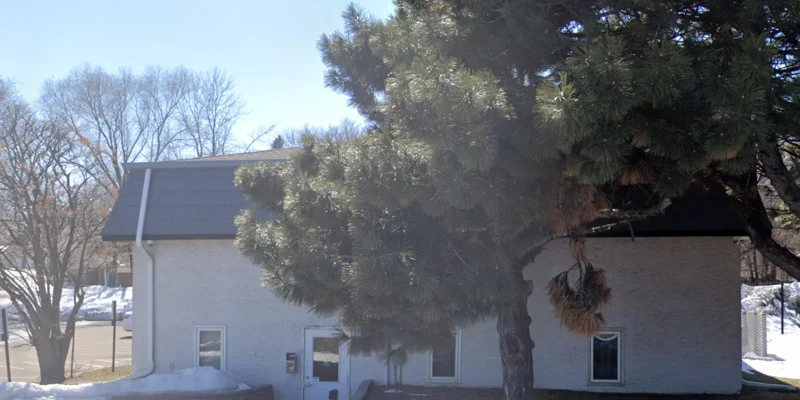 Facility exterior tree in front of entrance.