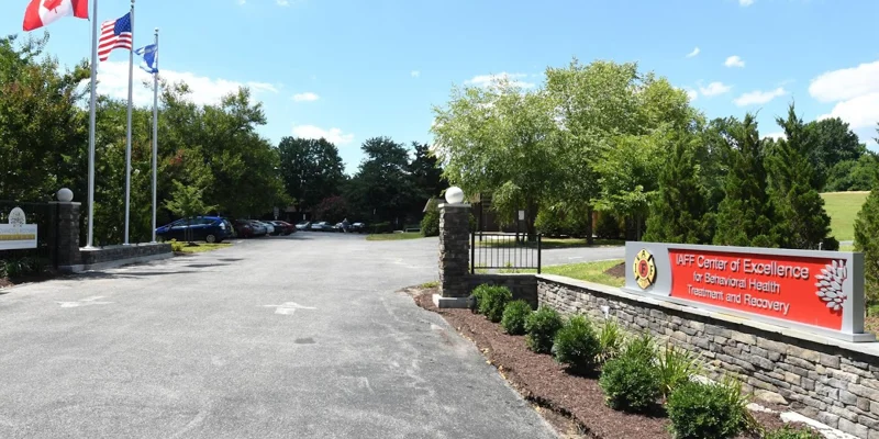 Driveway to the Facility with signage at entrance.