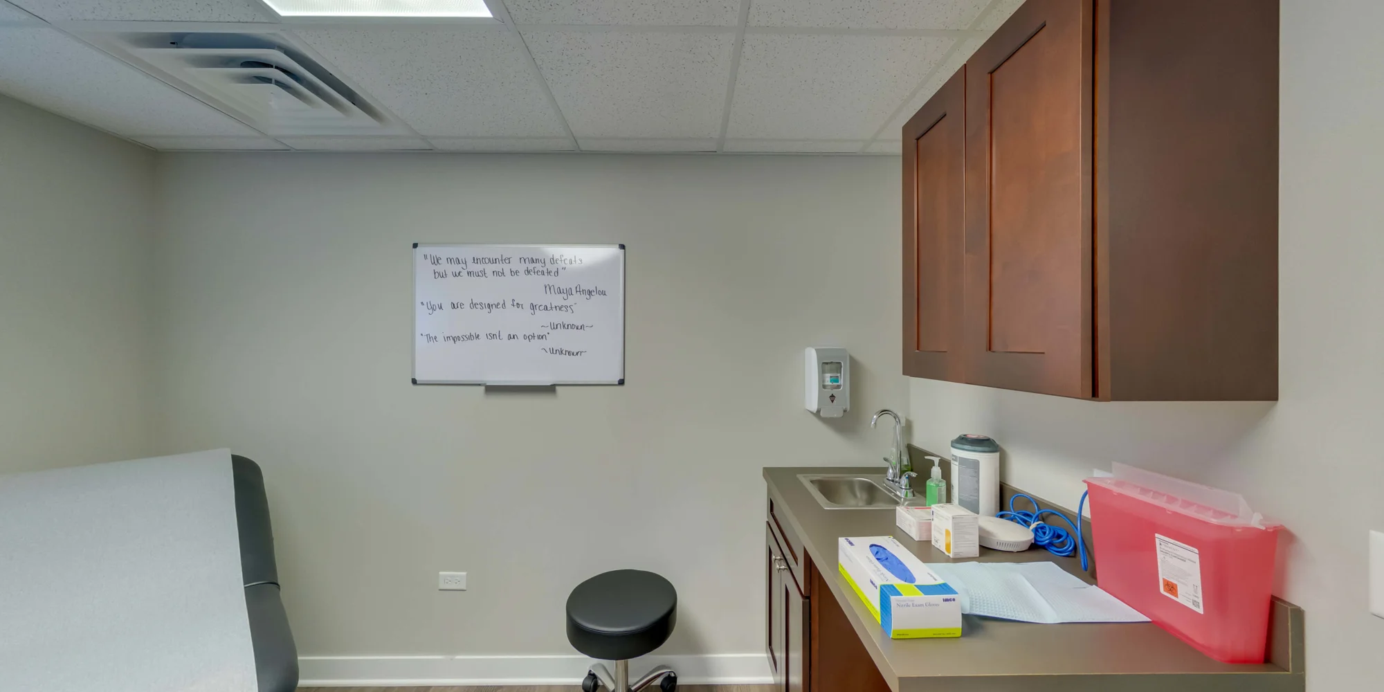 Examination room with a chair, and whiteboard in background.