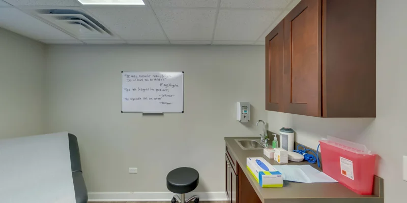 Examination room with a chair, and whiteboard in background.