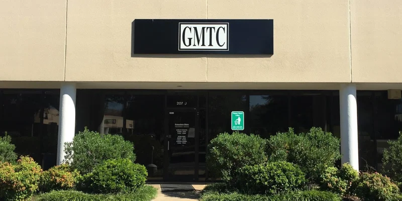 Facility entrance with parking.
