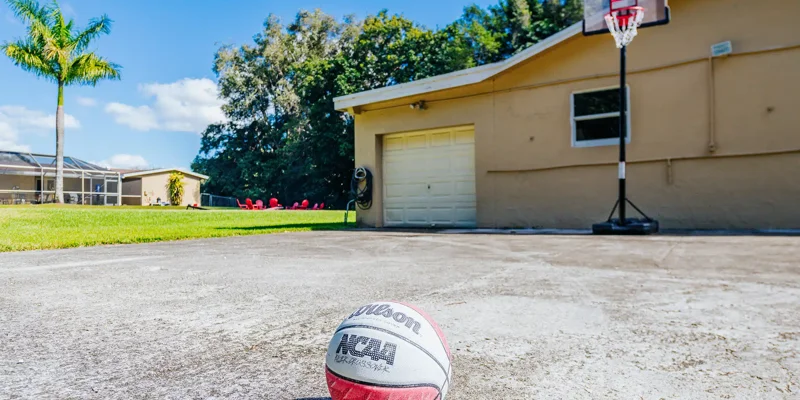 Outdoor hoop and basketball on a concrete court