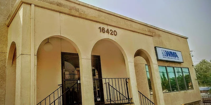 Beige building with arched entryway and signage
