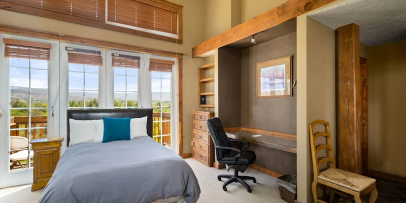 Private bedroom with a bed and desk.