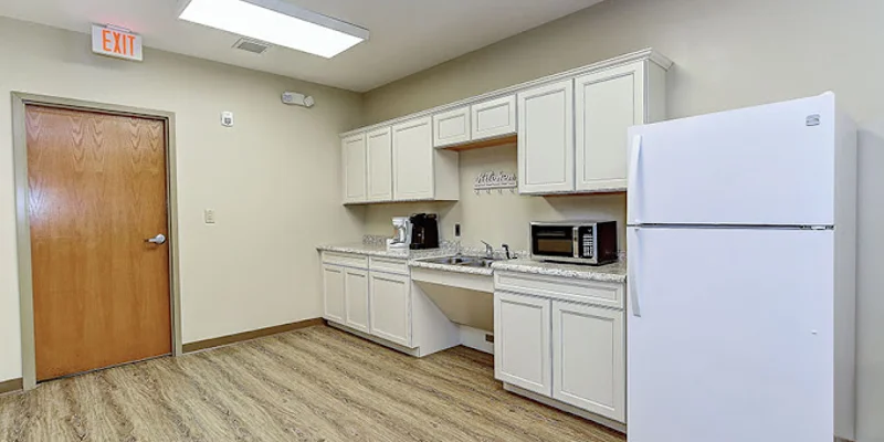 Small kitchenette with fridge, microwave, and coffee maker.