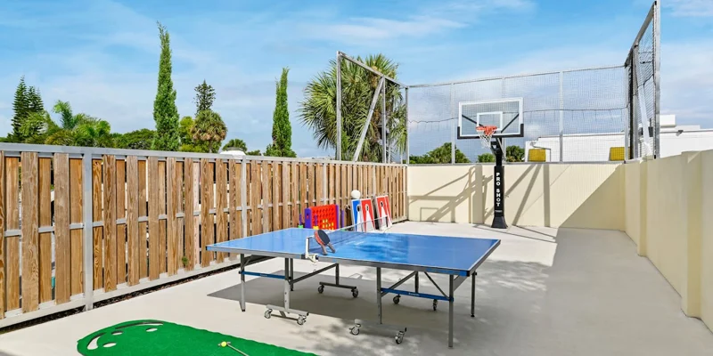 Outdoor recreation space with ping-pong, basketball, and mini-golf.