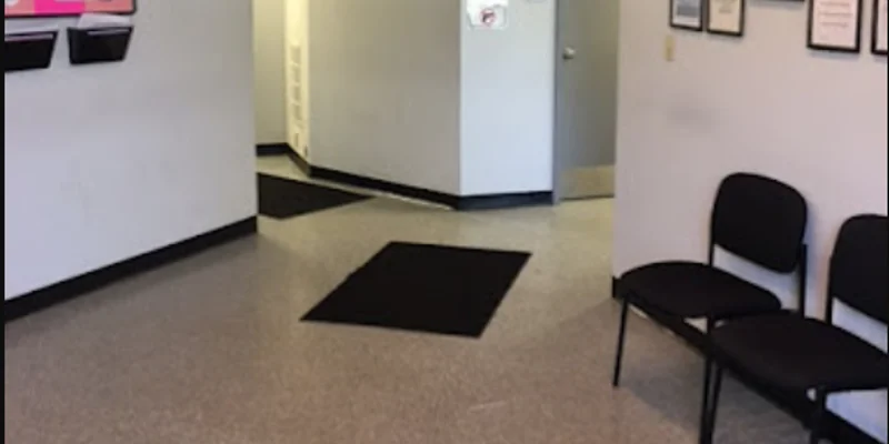 Waiting area with chairs and a bulletin board.