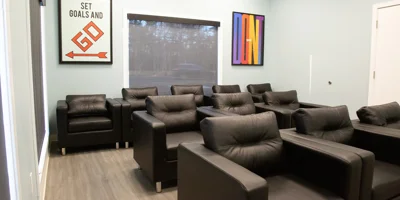 Lounge area with chairs and artwork.