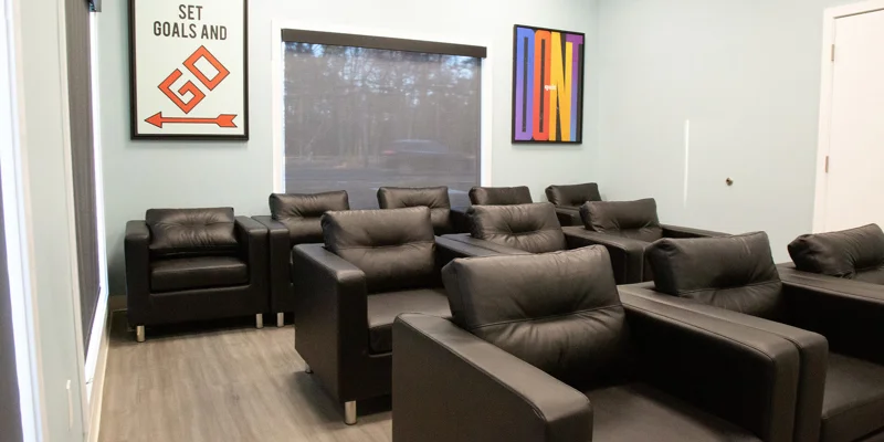 Lounge area with chairs and artwork.