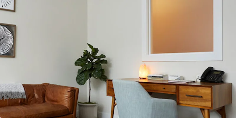 Office space with a desk and a couch.