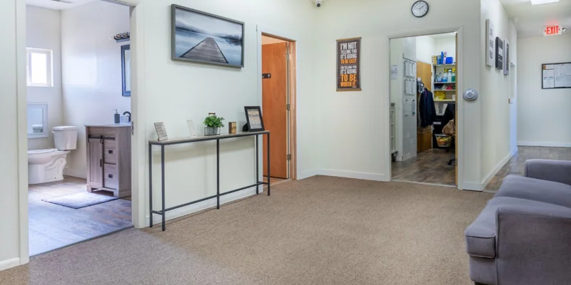 Hallway with a small table, chairs, and decor