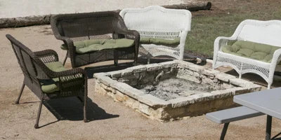 Outdoor seating area with a stone fire pit.