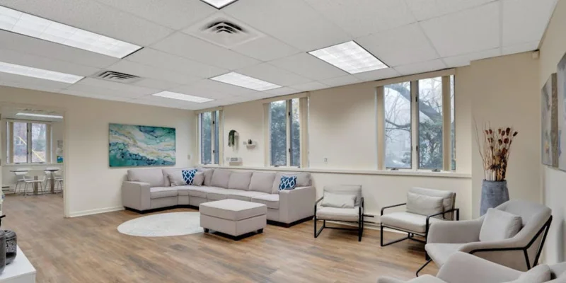 Living area with a couch and armchairs.