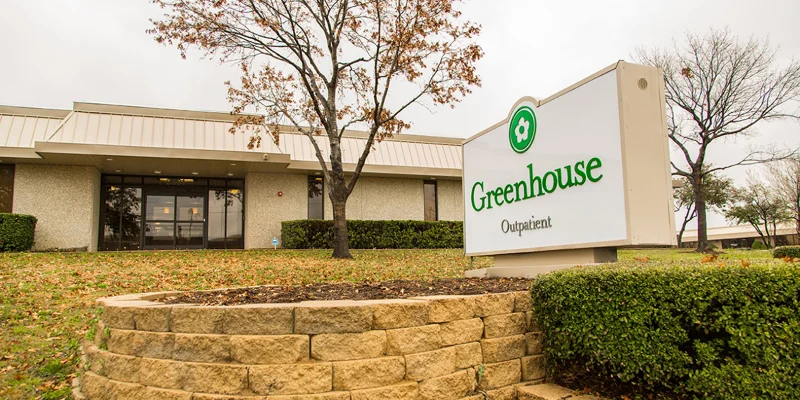  Exterior of Greenhouse Outpatient Center with signage and landscaped entrance